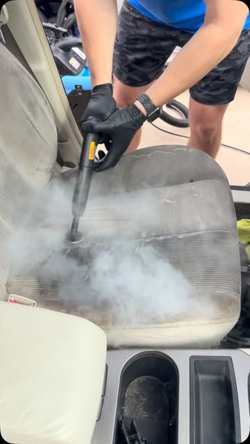 Apex detailer steam cleaning a dirty cloth seat