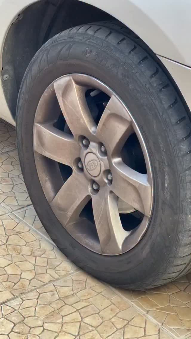Dusty alloy wheel and tire before cleaning
